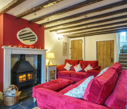 Riverside Cottage | Cosy living room with fire